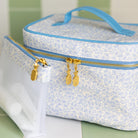 Blue floral makeup organizer with gold hardware on vanity by Simplified by Emily Ley